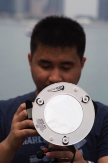 Photographer uses special eclipse filter on lens